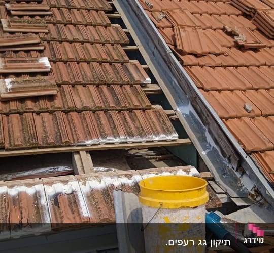 תיקון גג רעפים עם דליים וכלים